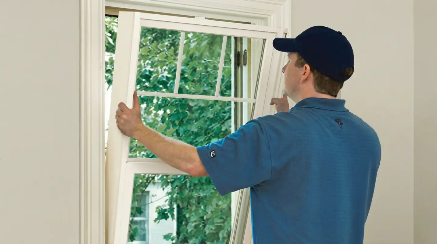 Professional contractors performing a residential window insulation and replacement service in Raleigh, NC