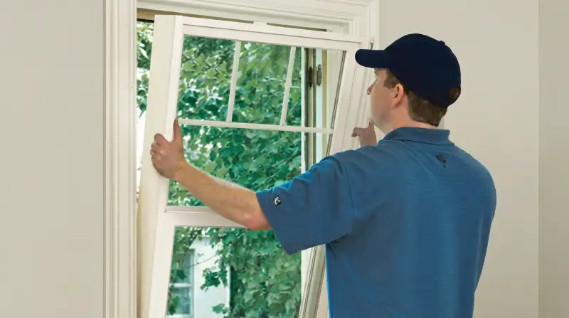 Professional contractors performing a residential window insulation and replacement service in Raleigh, NC